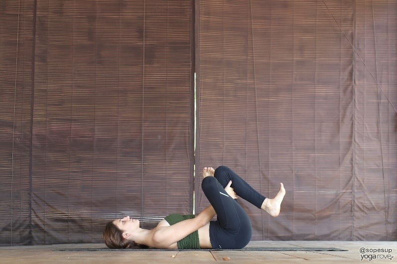 yogi practicing reclined pigeon pose 