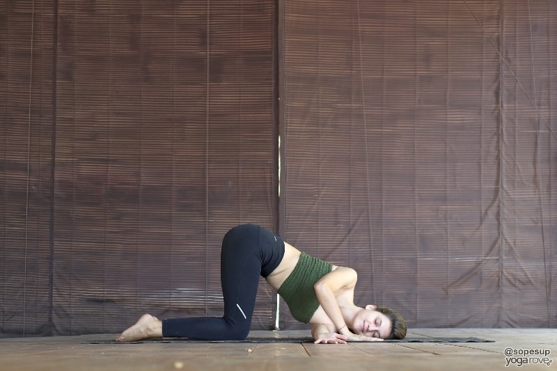 yogi practicing thread the needle restorative pose