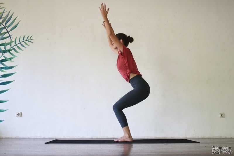 yogi practicing chair pose to build muscle