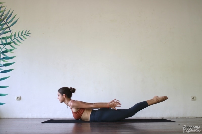 yogi practicing locust pose for muscle
