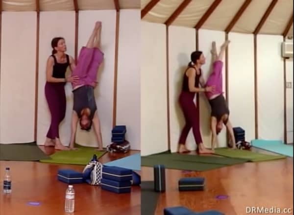 instructor helping student with Anusara yoga pose