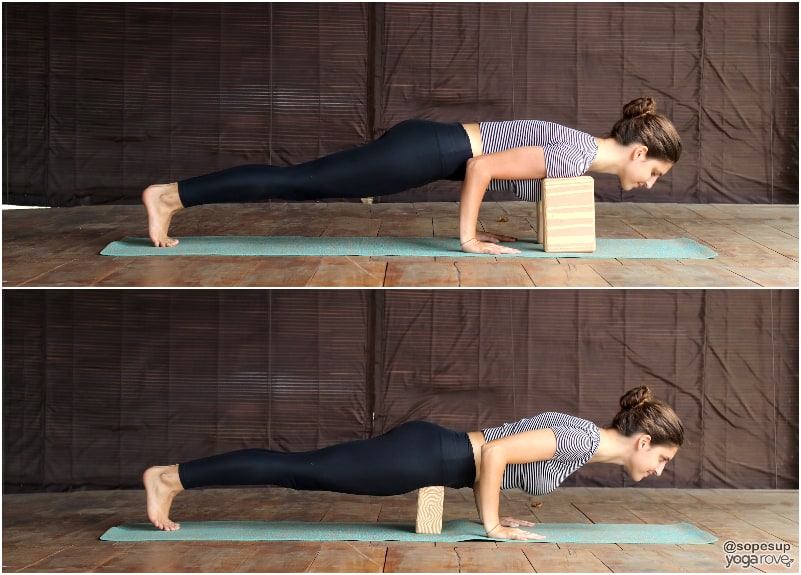 yogi practicing chaturanga  with block under shoulders and block under hips.