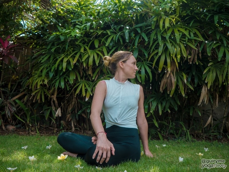 yogi practicing easy seated twist to warm up