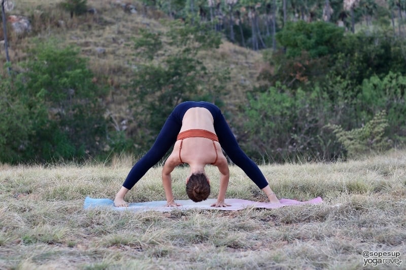 yogi practicing wide legged forward fold- gentle yoga