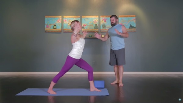 instructor teaching student Viniyoga poses