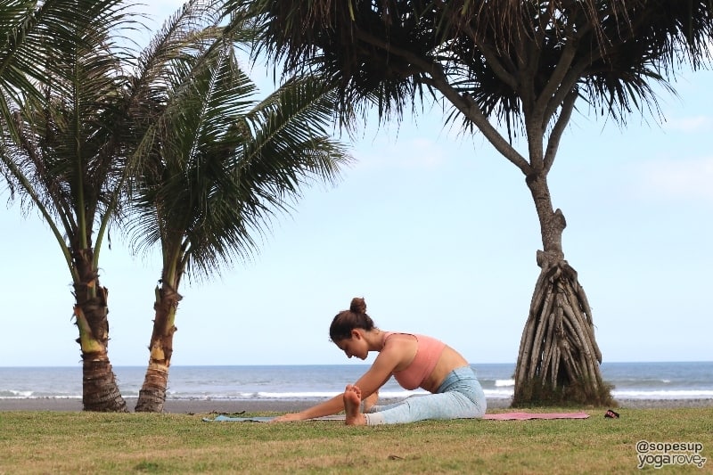 yogi practicing wide legged fold post run.