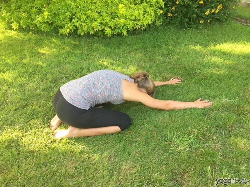 Yogi practicing child's pose- pain between shoulder blades