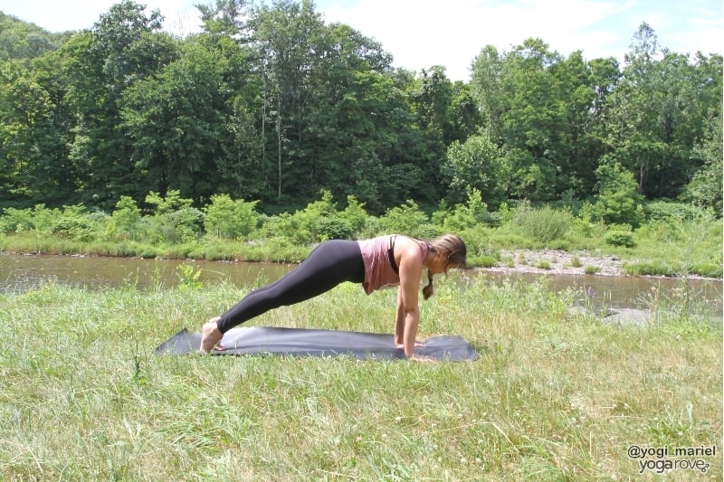 yogi practicing plank in sweaty yoga practice