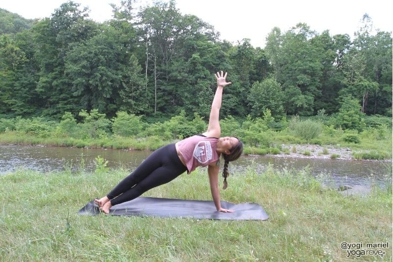 yogi practicing side plank in sweaty yoga practice