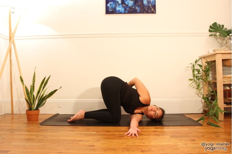 yogi practicing thread the needle pose variation with bind.