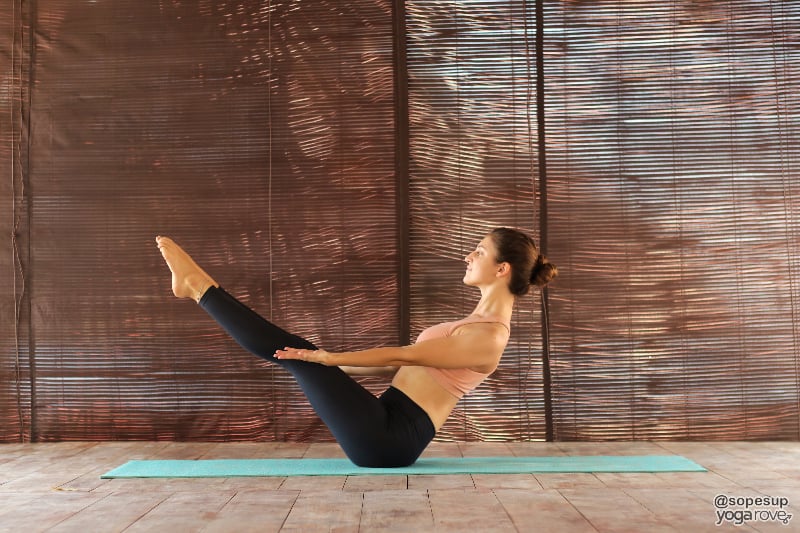 yogi practicing proper alignment in boat pose.