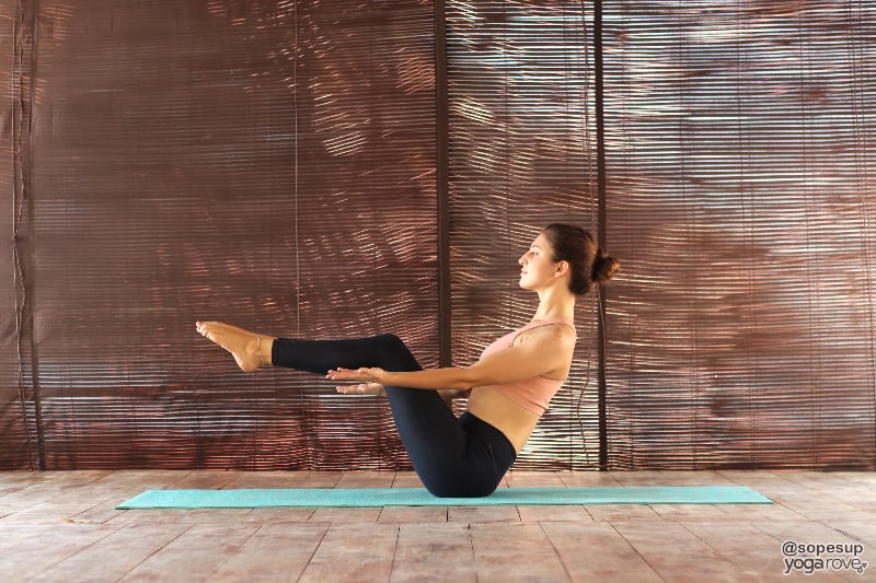 yogi practicing half boat pose.