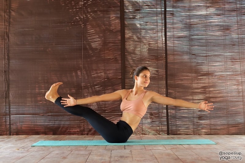 yogi practicing twisted boat variation