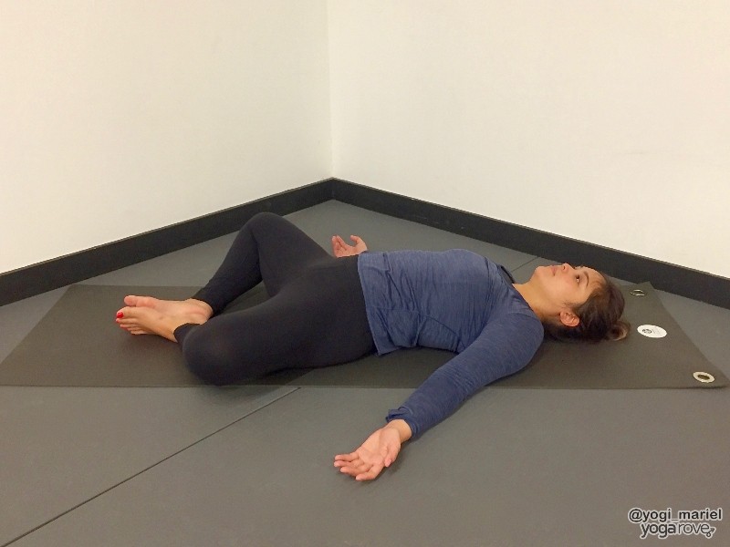 Yogi practicing reclined bound angle pose for sore muscles.