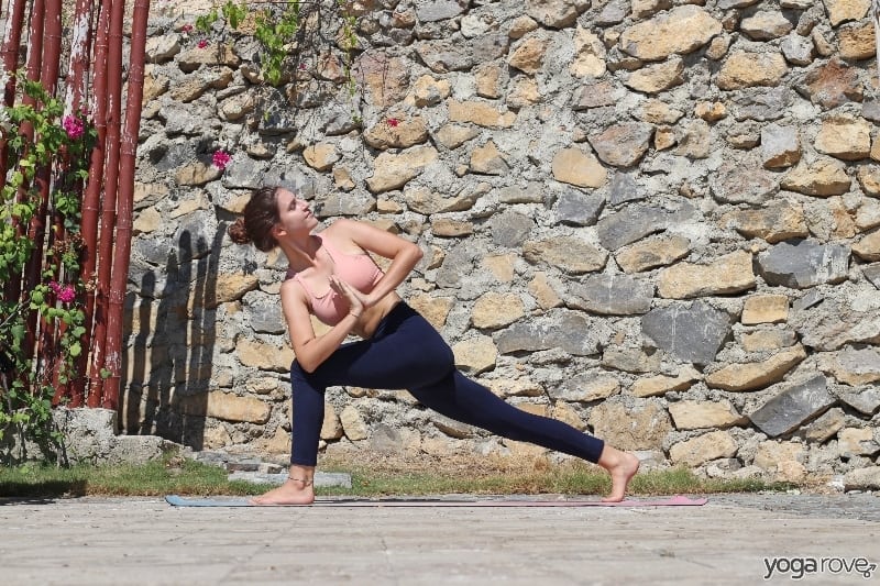 yogi practicing high lunge yoga twist