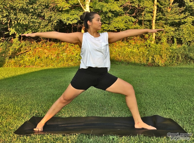 yogi practicing warrior II to warm up for triangle