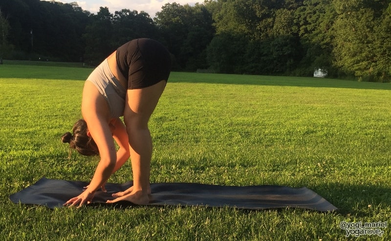 yogi practicing standing forward fold pose in hatha yoga